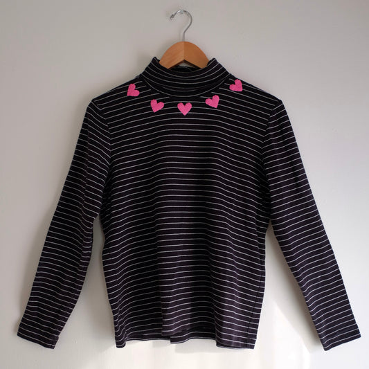 black turtleneck with thin white stripes and hearts
