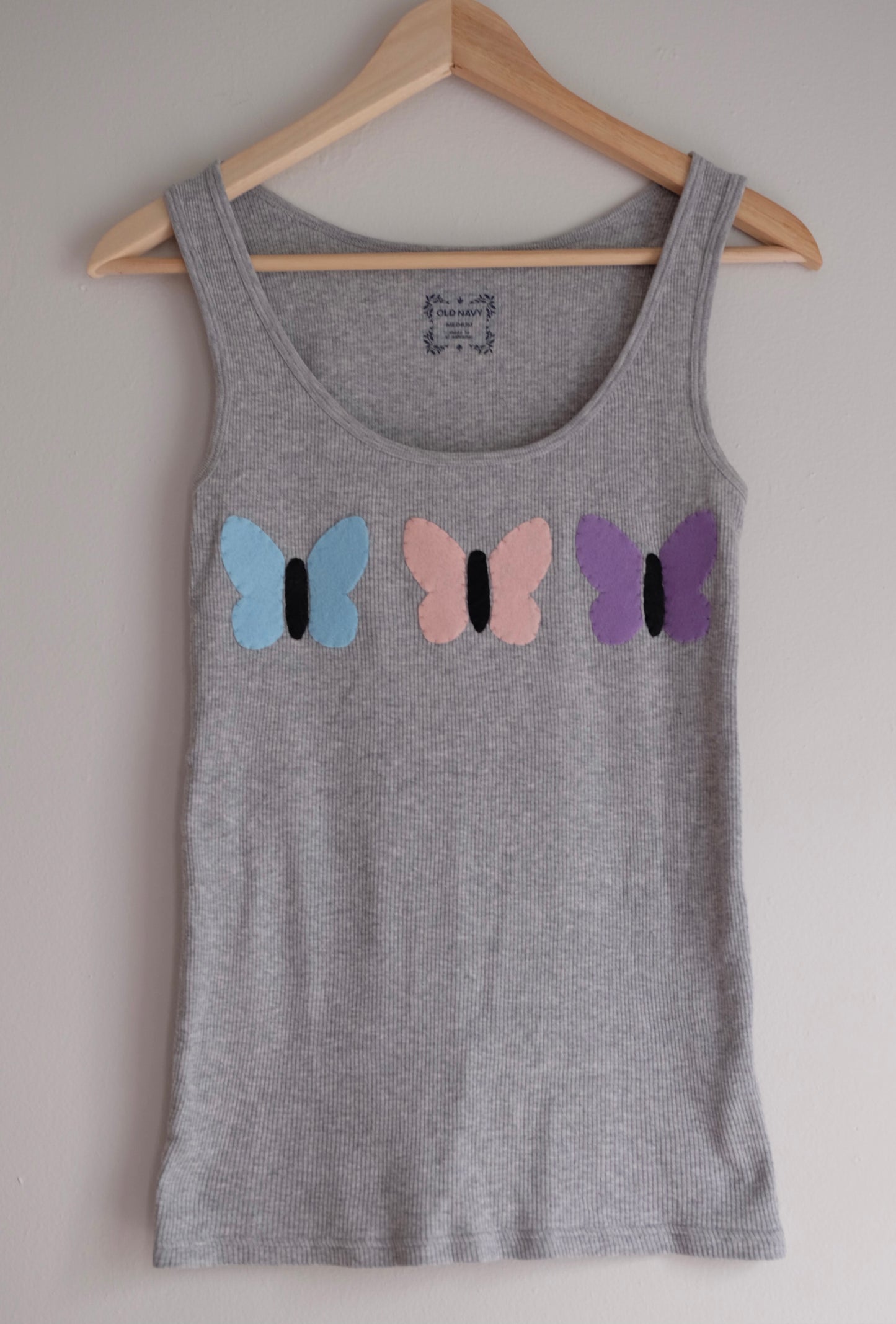 gray tank with butterflies