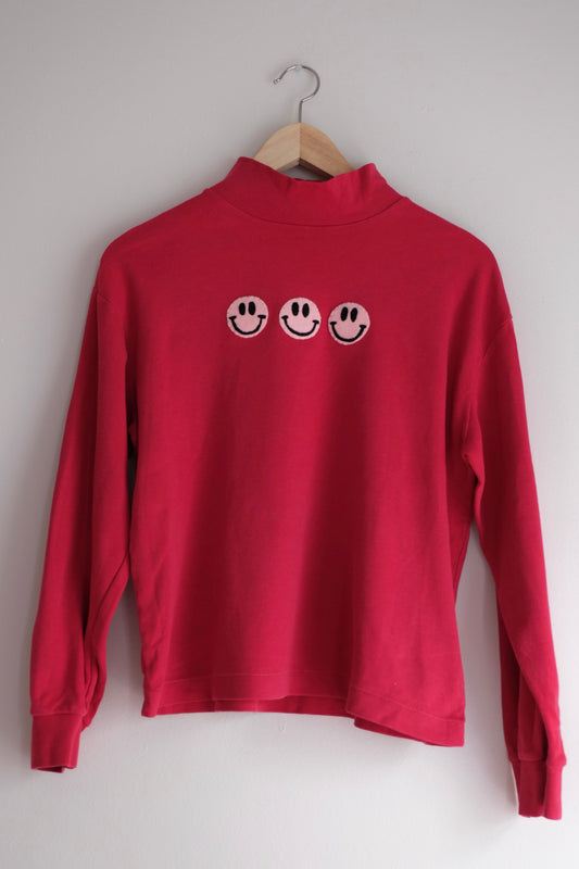 red mockneck with smiley faces